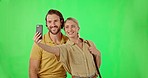 Selfie, phone and couple in studio with green screen for romance, love and happiness. Smile, happy and young man and woman from Canada taking a picture together on cellphone by chroma key background.