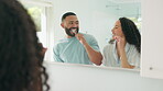 African couple, brushing teeth in mirror together in home bathroom and happy, man and wife smile with toothpaste or toothbrush in morning. People, dental care, healthy routine for mouth or smile