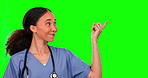 Green screen, nurse and woman pointing to mockup in studio isolated on a background. Face portrait, medical professional and happy person with product placement, advertising or marketing space.