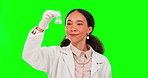 Science, thumbs up and a woman mixing on a green screen background in studio for chemical safety. Portrait, experiment and reaction with a female scientist on chromakey mockup to review a solution