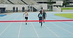 Team of track runners running to a finish line to win in competitive sports stadium event. Fit, active, athletic athletes sprinting. Diverse group of racing championship competitors competing