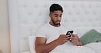 Man, phone and sad in bedroom with message, reading and texting with depression for post on social media. Young guy, smartphone and bed with disappointed face for chat, email or communication in room