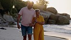 Retirement, couple and holding hands for walking on beach, sunshine vacation and holiday to relax in freedom. Happy man, woman and senior people in love at ocean for quality time, happiness and flare