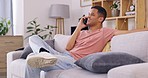 Man, laughing and talking with phone call in living room for communication, networking and chat on sofa. Happy guy,  smartphone and conversation on mobile technology for contact, hello and connection