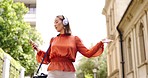 Phone, music and woman dance in a city with headphones, happy and good mood outdoors. Radio, street and asian female dancing to podcast while walking, excited and cheerful, free or positive in London