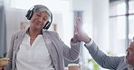 Coffee, headphones and senior business people high five in office streaming podcast, music and radio. Tea, celebrate and female professional listening to audio and walking with drink for happy friend