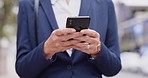 Business woman, phone and hands outdoor in the city with web networking and communication. Texting, person and internet scroll on social media app with mobile typing on a network on urban street