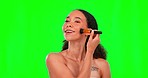 Brush, makeup and face of woman on green screen for wellness, beauty and cosmetics in studio. Cosmetology, skincare and happy girl with brushes for cosmetic application, foundation and products