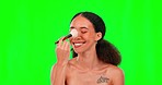 Makeup brush, nose and face of woman on green screen for wellness, beauty and cosmetics in studio. Cosmetology, skincare and happy girl with brushes for foundation application, glamour and contour