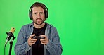 Live streaming, gaming and face of a man on a green screen isolated on a studio background. Mockup space, geek and portrait of a gamer talking while playing online games and recording a game