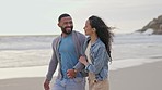 Happy couple, walking and holding hands on the beach for fun summer break, holiday or weekend together. Man and woman on sunset walk and smile in happiness for bonding relationship on the ocean coast