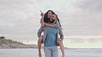 Piggy back, love and couple on beach at sunset for quality time, bonding and romance on weekend in nature. Travel, dating and happy woman and man walking by ocean for holiday, vacation and adventure