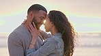 Couple, forehead together and beach at sunset with love, hug or romance with smile, nature or care. Man, woman and face touch with happiness, lens flare and outdoor for vacation, holiday or adventure