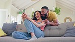 Happy couple, phone and video call laughing for funny joke, conversation or discussion on living room sofa at home. Man and woman relaxing and talking on smartphone with laugh for fun communication