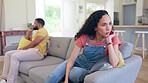 Couple, separation and fight on sofa in divorce, conflict or argument in living room dispute at home. Angry or upset man and woman on couch in depression after disagreement, ignore or fighting