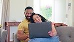 Love, relax and couple with laptop on a sofa for streaming, entertainment and bonding in their home. Online, entertainment and man embrace woman in a living room while enjoying subscription service