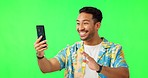 Video call, wave and man in green screen studio excited, smile and happy on mockup background. Hello, hand and asian guy travel influencer live streaming, content creation or blog to online followers