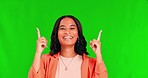 Business woman, green screen and face with pointing up to mockup space for announcement. Studio, female person and employee portrait with a smile showing product placement and deal coming soon