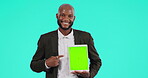 Screen, pointing and black man with tablet in studio with display, marketing or advertising mockup on blue background. Businessman, face or promotion of mobile technology, information or presentation