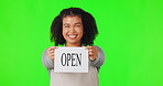 Happy woman, open sign and green screen in small business advertising against a studio background. Portrait of female person, waitress or store owner showing billboard and ready for service on mockup