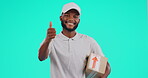 Portrait, delivery and thumbs up with a black man courier in studio on a blue background holding a box. Logistics, ecommerce or package and a happy postal worker showing thank you with an emoji