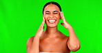 Green screen, happy woman and funny face with tongue for beauty, aesthetic glow and dermatology on studio background. Portrait, silly female model and touch soft skincare for natural facial results