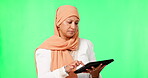 Woman, muslim and online on tablet in studio for social media, ecommerce or communication on green screen for technology. Islamic person, hijab and confused on internet, app or web search mock up