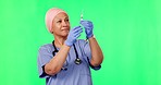 Green screen, doctor and Muslim woman with syringe for medicine, medical treatment and vaccine in studio. Healthcare, chromakey and female worker with needle for wellness, medication and injection