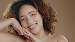 Black woman face, skin glow and beauty wellness of a model in a studio with happiness. Dermatology, closeup and African person portrait with a smile from skincare in a isolated brown background