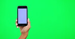 Hand, mockup and a person with a phone on green screen for website, internet or network promo. Hands of a model with a smartphone for online advertising, ux or ui information on a studio background