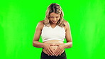 Pregnant, heart and stomach of a happy woman on a green screen with a smile, hope and love. Excited female person with hand sign or shape for pregnancy, health and wellness on a studio background