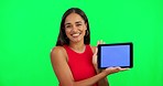 Woman, green screen and tablet with face, ux or mockup space for logo, branding and review with smile. Girl, model or  young student with digital touchscreen, mock up and happy with promotion for app