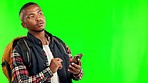 Green screen, travel and black man with a smartphone, location or tourist on a studio background. Male person, traveler or model with a cellphone, search internet or freedom with tourism or direction