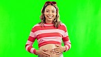 Surprised, pregnant woman and baby kick on green screen for body wellness or development. Pregnancy, excited person and mother touch belly for love, happiness or healthy baby growth with wow reaction