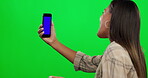 Woman, phone and video call on green screen for gen z communication, networking and influencer advice or tips. Virtual, smartphone and happy person in mockup and live streaming on studio background 