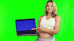 Pregnant woman, laptop and mockup on green screen for advertising against a studio background. Portrait of female person in maternity holding computer with mock up chromakey display for advertisement