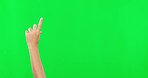 Person, hands and pointing on green screen for advertising against a studio background with mockup space. Hand of child, kid or teen with finger point for advertisement, announcement or sale discount
