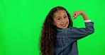 Girl child, strong muscle and green screen with face, flex and  mockup for children, fashion and happy for playing. Young female kid, playful and flexing bicep in comic portrait with trendy clothes