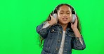 Green screen, headphones and girl or child listening, dance and singing for kids radio, podcast and talent. Dancing, celebration and happy kid with music and audio electronics on studio background