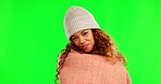 Blanket, cozy and face of a woman on a green screen isolated on a background in a studio. Happy, comfy and portrait of a young girl with warmth and happiness from a duvet for comfort in winter