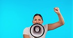 Woman face, megaphone and protest fist in studio for change, justice and vote, power or voice on blue background. Speech, noise and portrait of female speaker with bullhorn for news or announcement