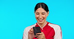 Phone, funny and girl reading in studio with meme, social media or smile on face for sports blog, joke on blue background. Mockup, athlete and laughing at internet, online or comedy on mobile app