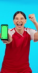 Phone, screen and celebration of woman with chroma key, marketing and athlete happy, winning and success or mockup. Winner, face and portrait of person in sports, competition on blue background