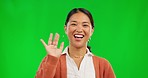 Face, wave and woman in video call on green screen isolated on a studio background mockup. Portrait, hello and person talking in virtual chat, webinar or online meeting, communication and happiness.