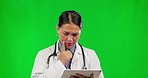 Asian woman, doctor and thinking with tablet on green screen in healthcare research against a studio background. Confused female person or medical professional in think, doubt or search on technology
