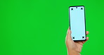 Hand, phone and green screen for marketing, app or advertising an announcement, promotion or logo on studi background. Hands, smartphone and chroma key for information, technology or branding mockup