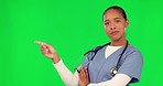 Doctor, woman pointing and green screen in healthcare presentation, information or advertising services. Face of medical person or nurse hand to show health news, mockup or space on studio background