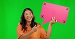 Happy asian woman, speech bubble and pointing on green screen for comment against a studio background. Portrait of female person with smile and icon for feedback, social media and tracking markers