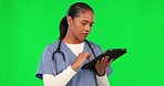 Digital tablet, green screen and female doctor in a studio doing medical research for diagnosis. Healthcare, thinking and woman nurse analyzing xrays with technology isolated by chroma key background
