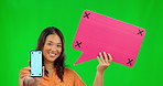 Asian woman, phone and mockup on green screen with speech bubble for social media against a studio background. Portrait of happy female person showing mobile smartphone app with tracking markers